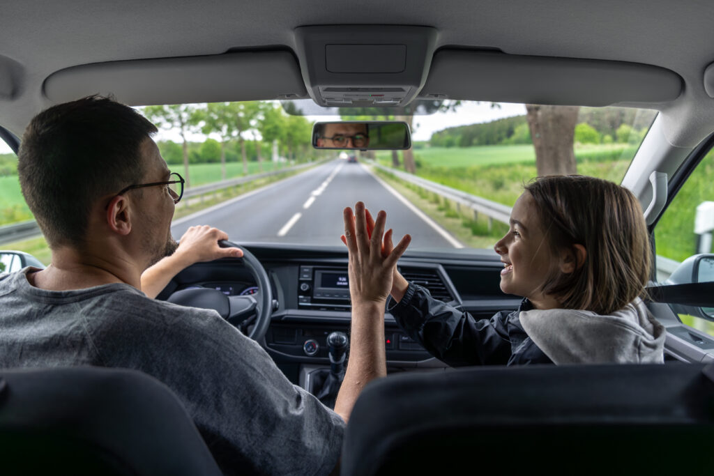 happy car ride. driver and child. joyful moment.